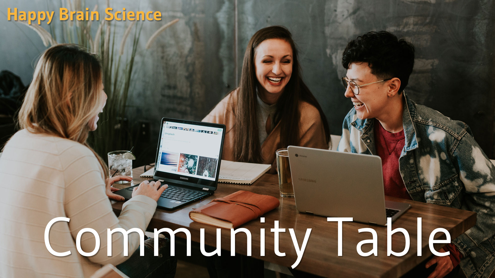 Community Table - image of colleagues laughing around a shared table