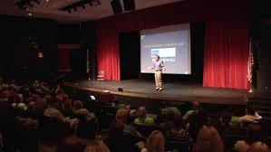 Scott Crabtree presenting to a large audience